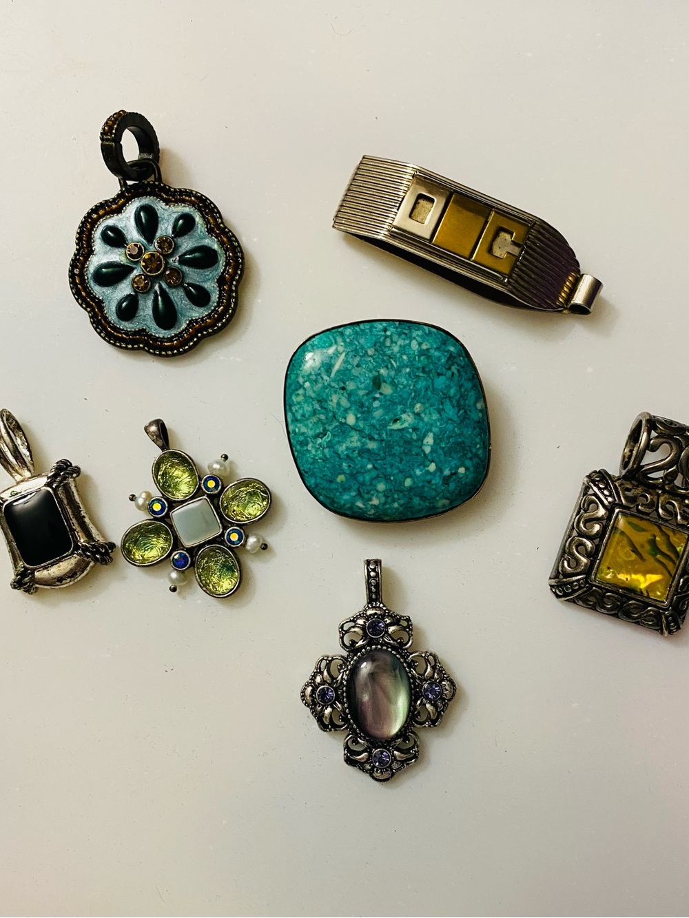A variety of Vintage Pendents and Clips (Black and Silver stamped "Avon"